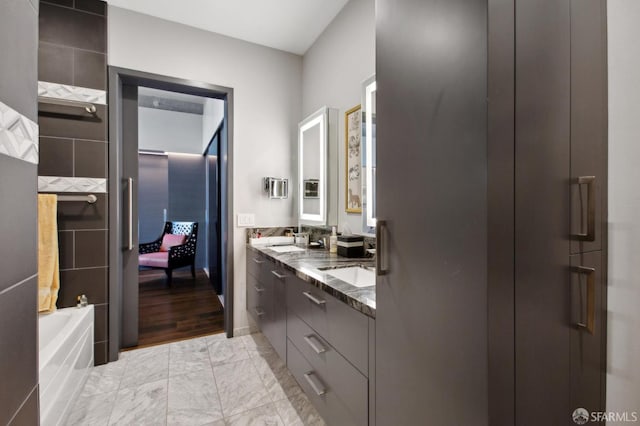 bathroom with a bath and vanity