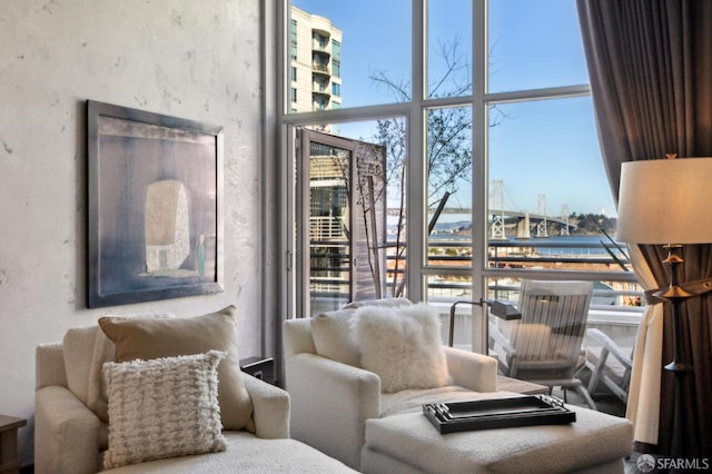 living room with a water view and a wall of windows