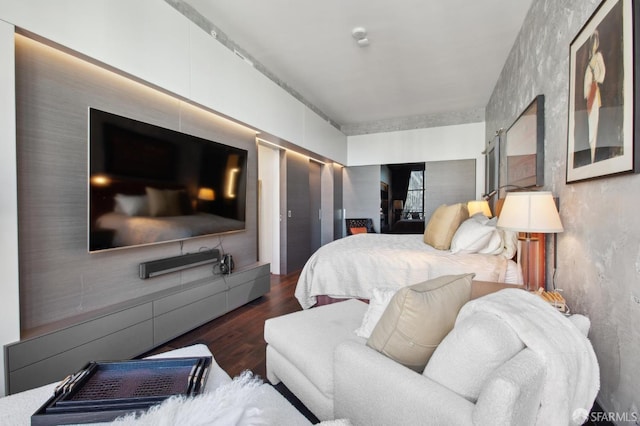 bedroom with dark wood-type flooring