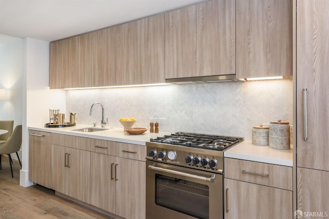 1288 Howard St Unit 418, San Francisco, CA 94103 - kitchen with stainless steel range, light brown cabinetry, and a sink