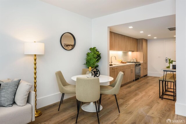 1288 Howard St Unit 418, San Francisco, CA 94103 - dining space with light wood-style flooring, recessed lighting, and baseboards
