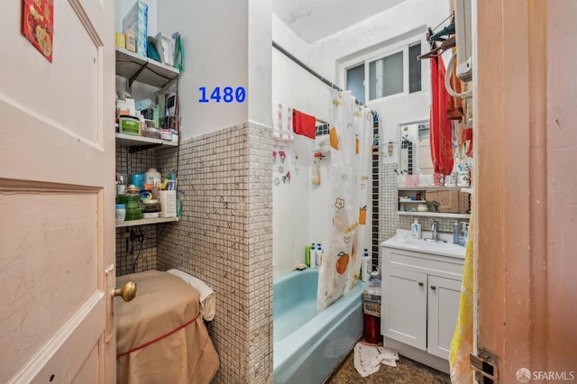 bathroom with backsplash, vanity, and shower / bath combo with shower curtain