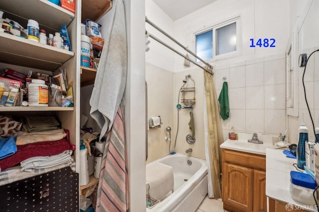 bathroom with  shower combination, vanity, and tile walls