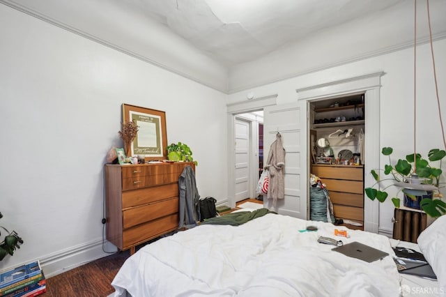 bedroom with dark wood-style floors and baseboards