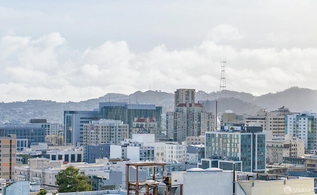 property's view of city with a mountain view