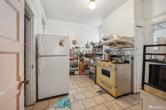 kitchen with light tile patterned floors and white appliances