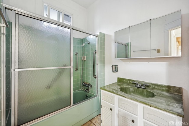 full bathroom with bath / shower combo with glass door and vanity