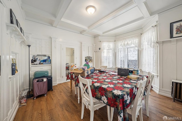 dining room featuring crown molding, beam ceiling, coffered ceiling, and wood finished floors