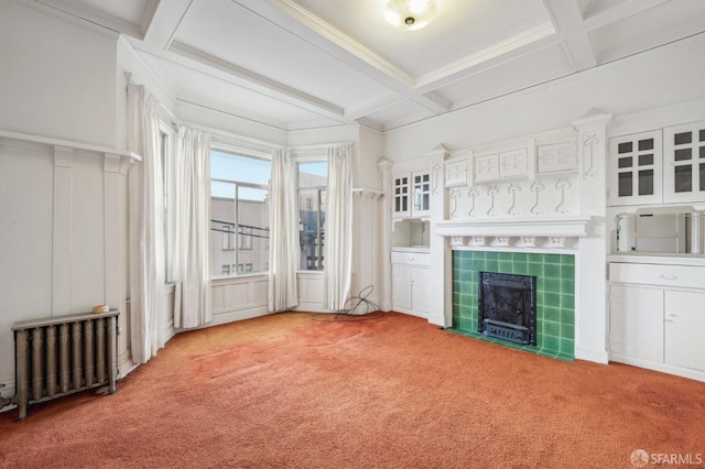 unfurnished living room with radiator heating unit, coffered ceiling, beam ceiling, and light colored carpet