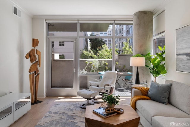 72 Townsend St Unit 302, San Francisco, CA 94107 - living room with ornamental molding, light wood-style flooring, and plenty of natural light