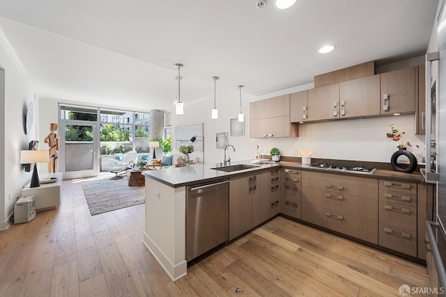 72 Townsend St Unit 302, San Francisco, CA 94107 - kitchen featuring stainless steel dishwasher, white gas cooktop, a peninsula, a sink, and light wood finished floors