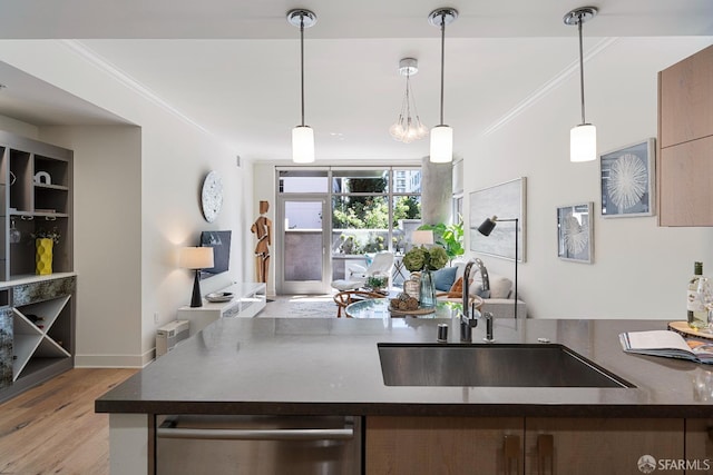 72 Townsend St Unit 302, San Francisco, CA 94107 - kitchen with a sink, dark countertops, crown molding, dishwasher, and wood finished floors