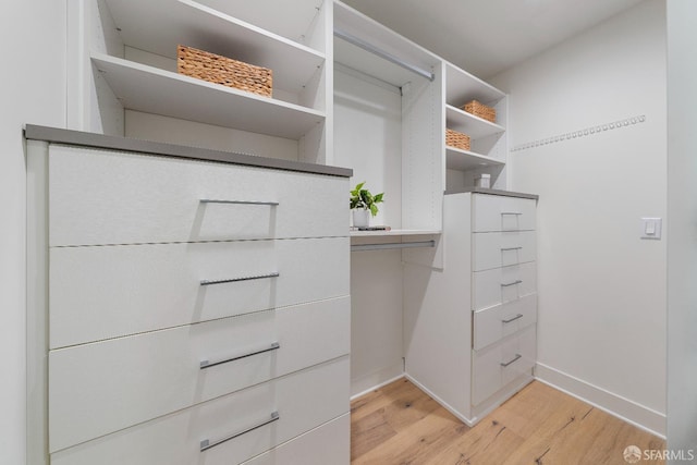 72 Townsend St Unit 302, San Francisco, CA 94107 - walk in closet featuring light wood-style flooring