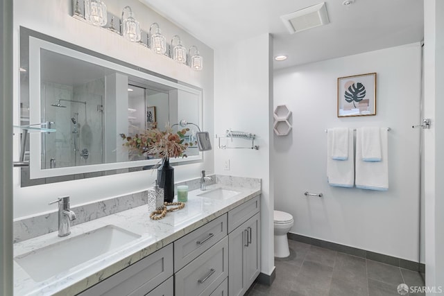 72 Townsend St Unit 302, San Francisco, CA 94107 - full bathroom with double vanity, a shower stall, toilet, baseboards, and tile patterned flooring
