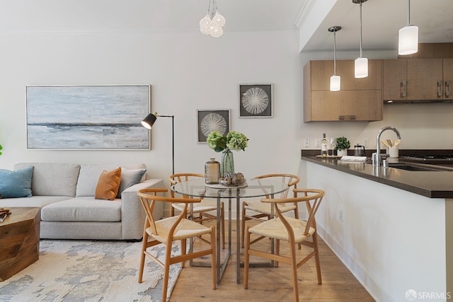 72 Townsend St Unit 302, San Francisco, CA 94107 - dining space featuring light wood-type flooring, crown molding, and baseboards