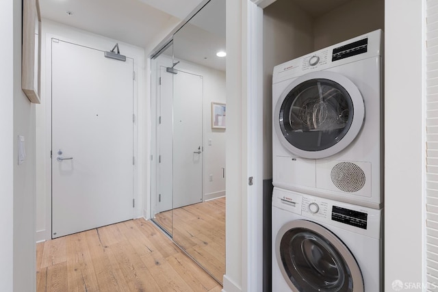 72 Townsend St Unit 302, San Francisco, CA 94107 - laundry area with stacked washer / dryer, light wood-style flooring, and recessed lighting