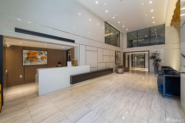72 Townsend St Unit 302, San Francisco, CA 94107 - welcome area with a high ceiling, wooden walls, and recessed lighting