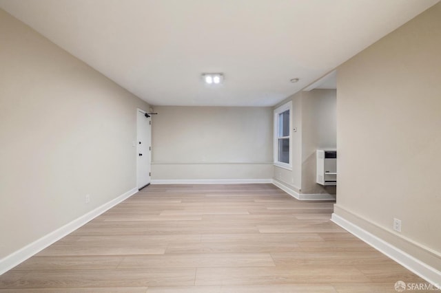 unfurnished room with light hardwood / wood-style floors