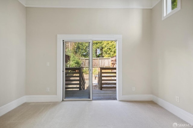 doorway with carpet flooring and ornamental molding