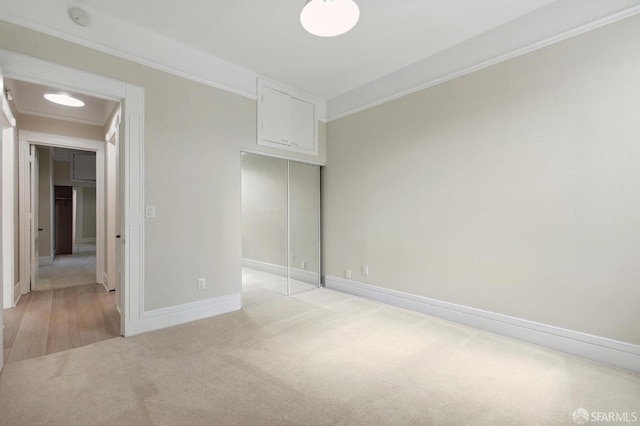 unfurnished bedroom with crown molding and light colored carpet