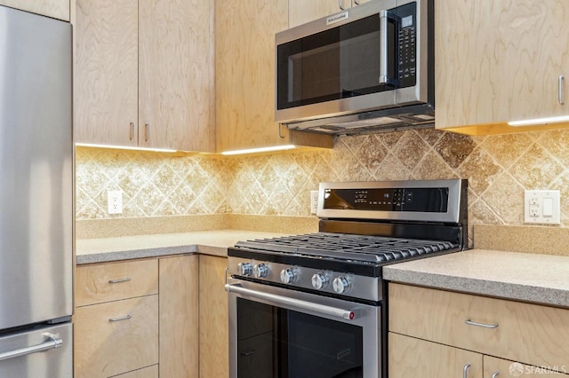 kitchen with decorative backsplash, light brown cabinets, and stainless steel appliances