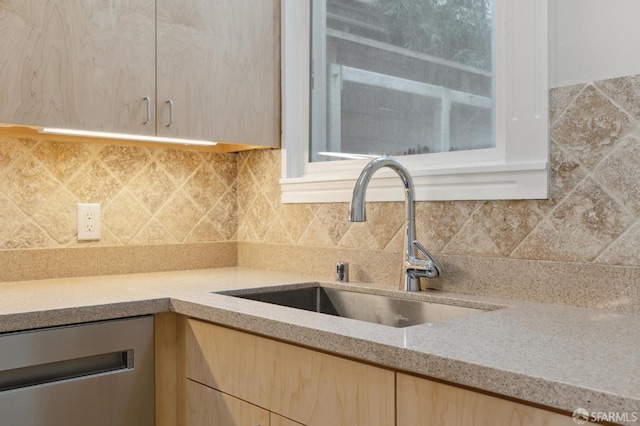 kitchen featuring tasteful backsplash, wine cooler, sink, light stone countertops, and light brown cabinetry