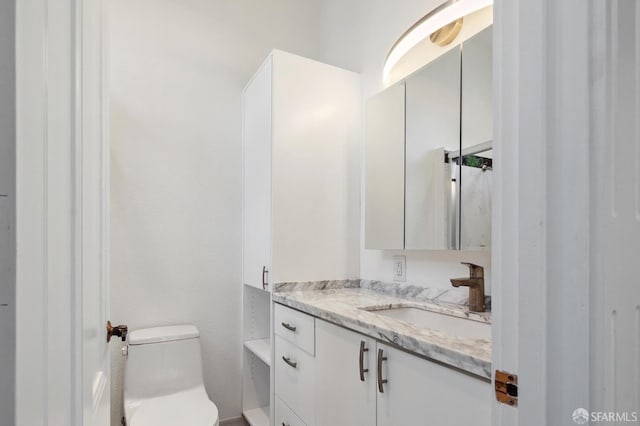 bathroom featuring toilet and vanity