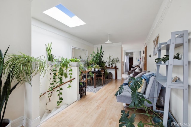 hallway with hardwood / wood-style flooring and crown molding