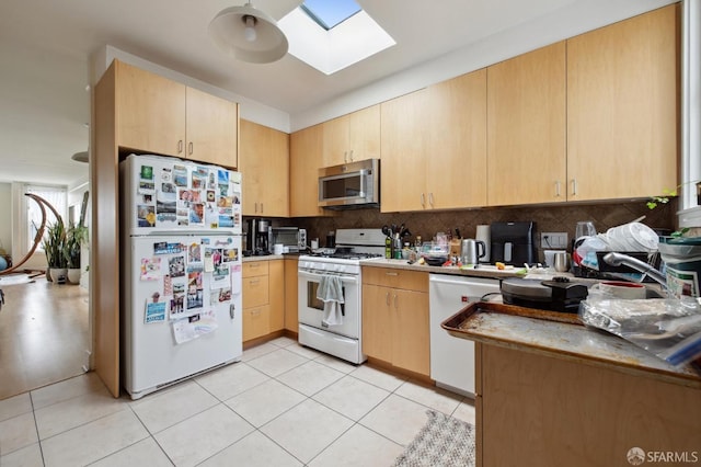 kitchen featuring light tile patterned floors, light brown cabinetry, a skylight, and white appliances