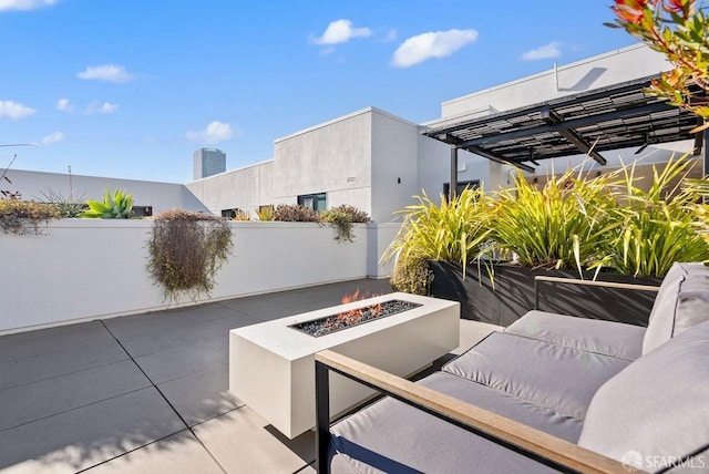 view of patio / terrace featuring an outdoor living space with a fire pit and a pergola