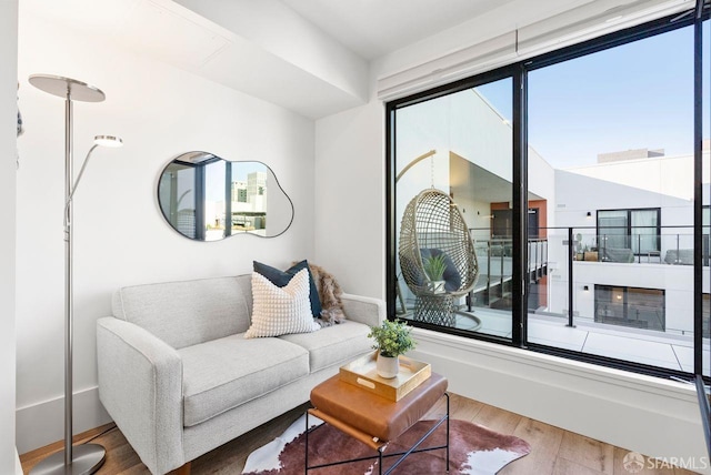 living room with a wealth of natural light and wood-type flooring