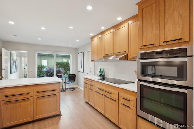 kitchen with light hardwood / wood-style flooring, black electric stovetop, decorative backsplash, stainless steel double oven, and light brown cabinets