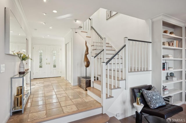 entrance foyer featuring ornamental molding