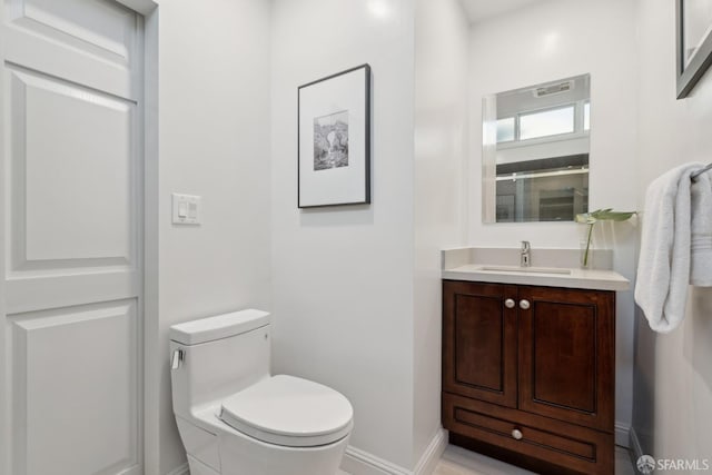 bathroom featuring vanity and toilet