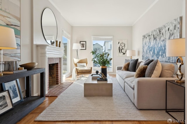 living room with hardwood / wood-style flooring and a brick fireplace