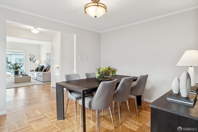 dining area featuring light parquet flooring and crown molding