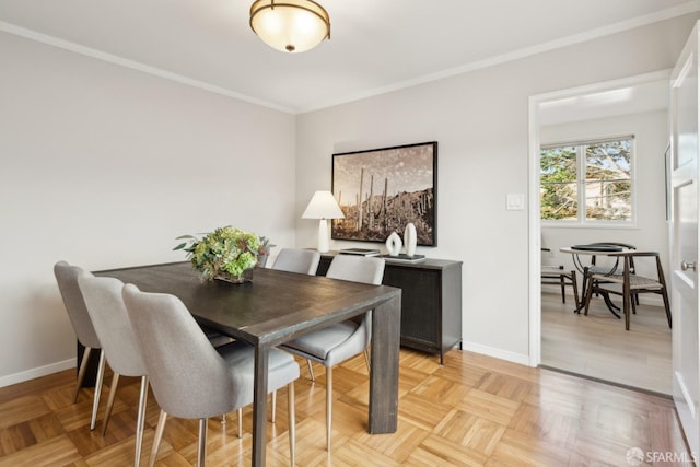 dining area with light parquet floors and ornamental molding