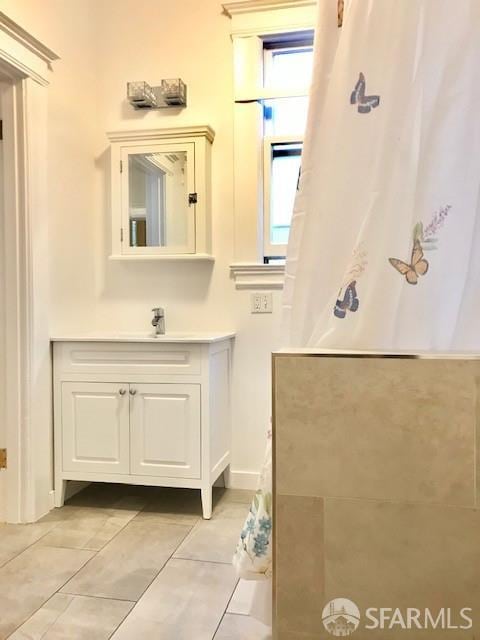 full bath featuring vanity and tile patterned floors