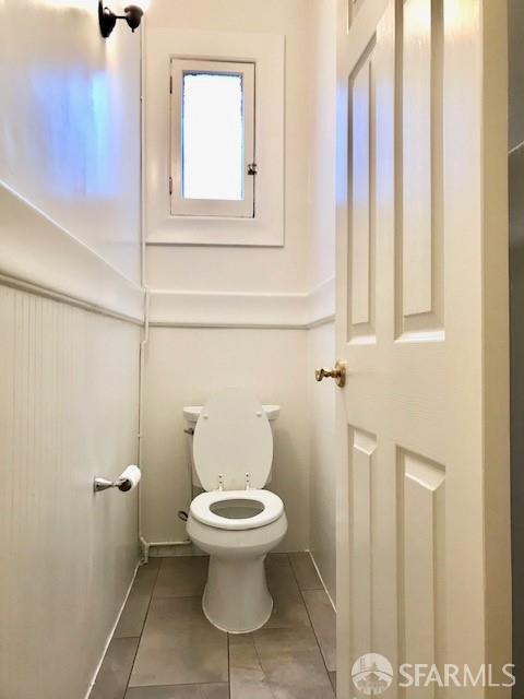 bathroom featuring toilet and tile patterned flooring