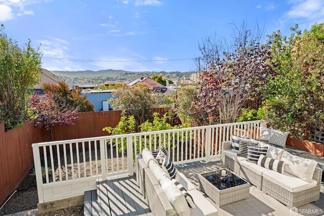 deck with a mountain view and an outdoor living space