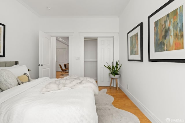 bedroom with light hardwood / wood-style floors and ornamental molding