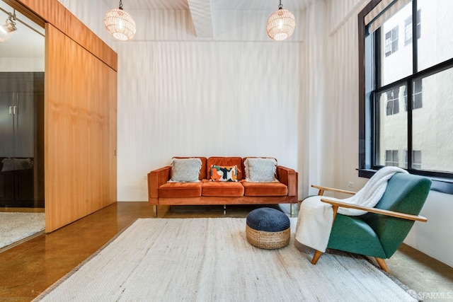 interior space with concrete floors and a chandelier