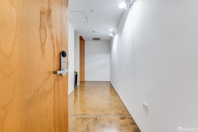 hall featuring concrete flooring