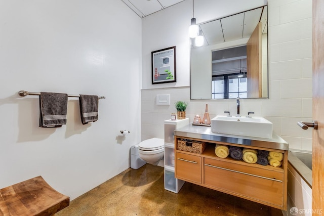 bathroom featuring concrete floors, toilet, and vanity