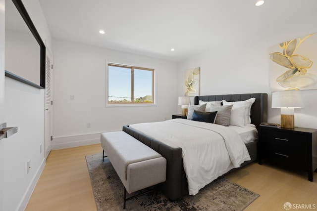 bedroom with light wood-style flooring, recessed lighting, and baseboards