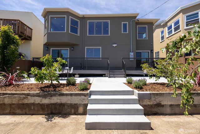 view of front of property with stucco siding and a deck