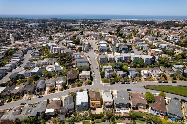 aerial view of property and surrounding area with nearby suburban area