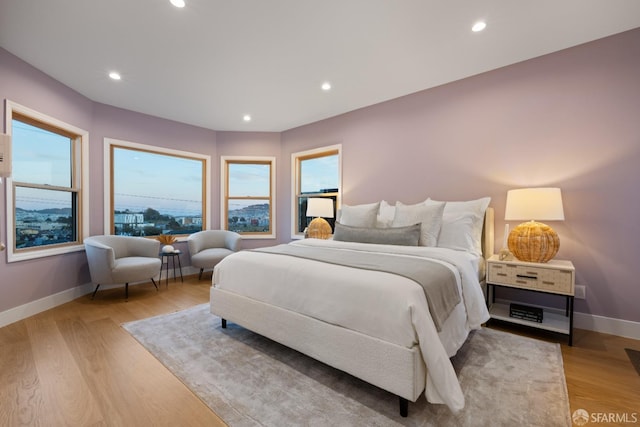 bedroom with baseboards, light wood-style floors, and recessed lighting