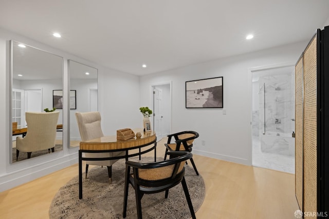 dining space featuring light wood finished floors, recessed lighting, and baseboards