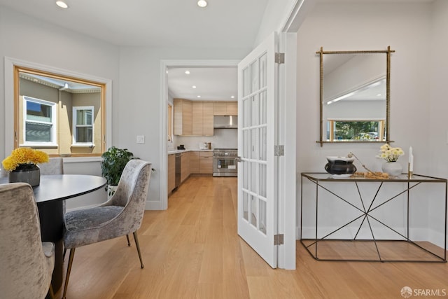 dining space with light wood finished floors and recessed lighting